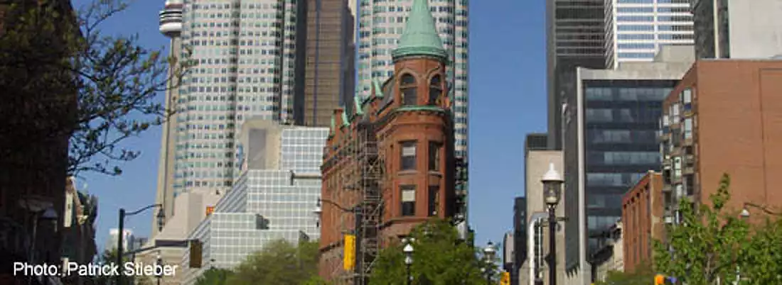 Flatiron Building With Downtown Office Towers
